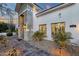 Stone facade highlights front door with transom window and decorative sconces at 8713 N 80Th Pl, Scottsdale, AZ 85258