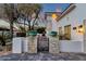 Stone pillars and pavers create a walkway to the charming front gate at 8713 N 80Th Pl, Scottsdale, AZ 85258
