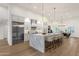 Modern kitchen with stainless steel appliances, a marble island with seating, and hardwood floors at 8713 N 80Th Pl, Scottsdale, AZ 85258