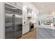 Modern kitchen with stainless steel appliances, white cabinets, marble countertops, and hardwood flooring at 8713 N 80Th Pl, Scottsdale, AZ 85258