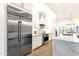 Bright kitchen boasts stainless steel fridge, white cabinetry, and marble countertops at 8713 N 80Th Pl, Scottsdale, AZ 85258