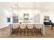 Modern kitchen island with marble countertop, barstool seating, stylish pendant lights and stainless steel appliances at 8713 N 80Th Pl, Scottsdale, AZ 85258
