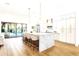 Bright kitchen with a large marble island, comfortable seating, and modern lighting fixtures, open to the pool area at 8713 N 80Th Pl, Scottsdale, AZ 85258