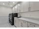 Laundry room with washer/dryer, a utility sink, and storage cabinets at 8713 N 80Th Pl, Scottsdale, AZ 85258