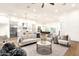 A sun-filled living room with plush seating, designer rug, and views into a modern kitchen at 8713 N 80Th Pl, Scottsdale, AZ 85258