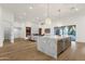 Open-concept living space featuring a modern kitchen island and a sleek fireplace at 8713 N 80Th Pl, Scottsdale, AZ 85258