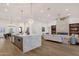 Open-concept living space featuring hardwood floors, a marble island, and comfortable furnishings at 8713 N 80Th Pl, Scottsdale, AZ 85258