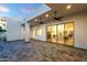 A luxurious outdoor patio with a stone floor, ceiling fans, and access to the indoors at 8713 N 80Th Pl, Scottsdale, AZ 85258