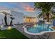 Modern outdoor pool with pavers, palms and grass offers relaxation and space at 8713 N 80Th Pl, Scottsdale, AZ 85258