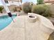 Poolside view of outdoor fire pit, covered patio and desert landscaping at 9761 W Yukon W Dr, Peoria, AZ 85382