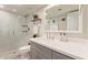 Renovated bathroom with glass enclosed shower, modern fixtures, and stone countertops at 1050 N 84Th Pl, Scottsdale, AZ 85257