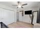 Bright bedroom featuring a ceiling fan, double door closet, full length mirror, and scenic outdoor view at 1050 N 84Th Pl, Scottsdale, AZ 85257