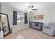 Charming Bedroom with crib, rocker, ceiling fan, and ample natural light from a window at 1050 N 84Th Pl, Scottsdale, AZ 85257