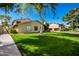 Inviting exterior of home featuring a lush front yard with mature trees and well-manicured lawn at 1050 N 84Th Pl, Scottsdale, AZ 85257