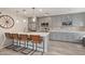 Modern kitchen featuring quartz countertops, stainless steel appliances, and gray cabinetry at 1050 N 84Th Pl, Scottsdale, AZ 85257