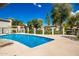 Community pool with clear blue water and lounge chairs surrounded by well-maintained landscaping on a bright sunny day at 1050 N 84Th Pl, Scottsdale, AZ 85257