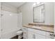 Bathroom with a white vanity, granite countertop, and tub with shower at 10630 W Pinchot Ave, Avondale, AZ 85392