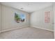 Neutral carpeted bedroom with natural light from a large window at 10630 W Pinchot Ave, Avondale, AZ 85392