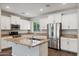 Beautiful kitchen featuring granite countertops, a center island, and stainless steel appliances at 10630 W Pinchot Ave, Avondale, AZ 85392