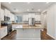 Bright kitchen with wood-look flooring, a large island, granite countertops, and stainless steel appliances at 10630 W Pinchot Ave, Avondale, AZ 85392