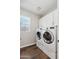 Convenient laundry room with a washer, dryer, storage cabinets, and a window at 10630 W Pinchot Ave, Avondale, AZ 85392