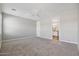 Spacious main bedroom with neutral carpet, a ceiling fan, and an ensuite bathroom at 10630 W Pinchot Ave, Avondale, AZ 85392