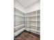 Spacious walk-in pantry with custom shelving for ample storage in this home at 10630 W Pinchot Ave, Avondale, AZ 85392