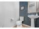 Stylish powder room featuring a pedestal sink and attractive tile accent wall at 10633 E Sheffield Dr, Mesa, AZ 85212