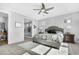 Bright bedroom featuring a ceiling fan, plush carpet, ensuite bath and plenty of natural light at 10633 E Sheffield Dr, Mesa, AZ 85212