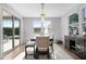 Bright dining room with chandelier lighting, access to the backyard, and contemporary furnishings at 10633 E Sheffield Dr, Mesa, AZ 85212