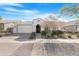 Charming single-story home with a well-manicured front yard and inviting arched entryway at 10633 E Sheffield Dr, Mesa, AZ 85212