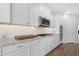 Bright kitchen with white cabinetry, stainless steel appliances, granite countertops, and wood-look flooring at 10633 E Sheffield Dr, Mesa, AZ 85212