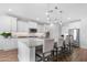 Well-lit kitchen featuring a spacious island with seating, stainless steel appliances and white cabinetry at 10633 E Sheffield Dr, Mesa, AZ 85212