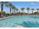 Relaxing pool with palm trees and lounge chairs creates a perfect community escape at 10633 E Sheffield Dr, Mesa, AZ 85212