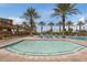 Inviting pool with a shallow splash area, surrounded by lush landscaping for a community retreat at 10633 E Sheffield Dr, Mesa, AZ 85212