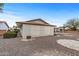 Rear exterior featuring a large garage, covered patio and low-maintenance desert landscaping at 10956 W Meade Dr, Sun City, AZ 85351