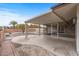 Backyard featuring desert landscaping, covered patio, and privacy wall, creating a serene outdoor retreat at 10956 W Meade Dr, Sun City, AZ 85351