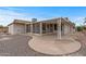 Exterior view of the rear of the house, showcasing a covered patio and low-maintenance desert landscaping at 10956 W Meade Dr, Sun City, AZ 85351