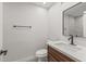 Modern half-bathroom with updated vanity, commode and decorative mirror at 10956 W Meade Dr, Sun City, AZ 85351