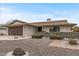 Welcoming single-story home with a well-manicured front yard featuring desert landscape and an attached garage at 10956 W Meade Dr, Sun City, AZ 85351