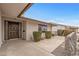 Inviting front entrance featuring a covered porch, mature landscaping, and a modern front door at 10956 W Meade Dr, Sun City, AZ 85351