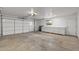 Spacious two car garage with workbench area and white storage cabinets at 10956 W Meade Dr, Sun City, AZ 85351