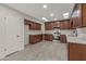 Well-lit kitchen features dark wood cabinets, stainless steel appliances, and white countertops at 10956 W Meade Dr, Sun City, AZ 85351