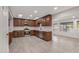 Modern kitchen with stainless steel appliances, dark wood cabinets, and white countertops at 10956 W Meade Dr, Sun City, AZ 85351