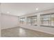 Bright living room with tile flooring and large windows offering abundant natural light and a view at 10956 W Meade Dr, Sun City, AZ 85351