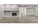 Bright living room with white stone fireplace, tile floors, recessed lighting, and direct access to the entry at 10956 W Meade Dr, Sun City, AZ 85351