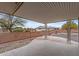 Covered patio with views of the desert-landscaped backyard and privacy wall at 10956 W Meade Dr, Sun City, AZ 85351