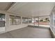 Enclosed patio featuring a concrete floor, screened walls, and natural light, offering a versatile outdoor living space at 10956 W Meade Dr, Sun City, AZ 85351