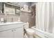 Tiled bathroom with updated vanity, mirror, and shower with curtain at 11468 N Desert Hills Dr, Sun City, AZ 85351