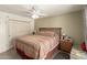 Neutral bedroom features a ceiling fan, closet, and natural light at 11468 N Desert Hills Dr, Sun City, AZ 85351